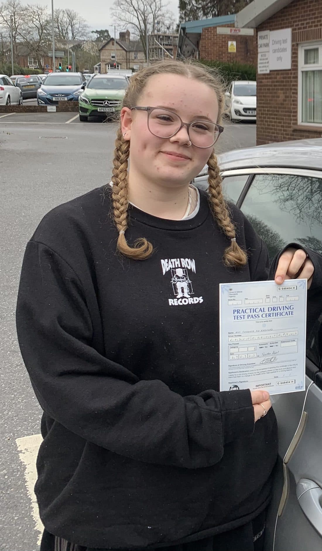 Learner driver holding their test pass certificate