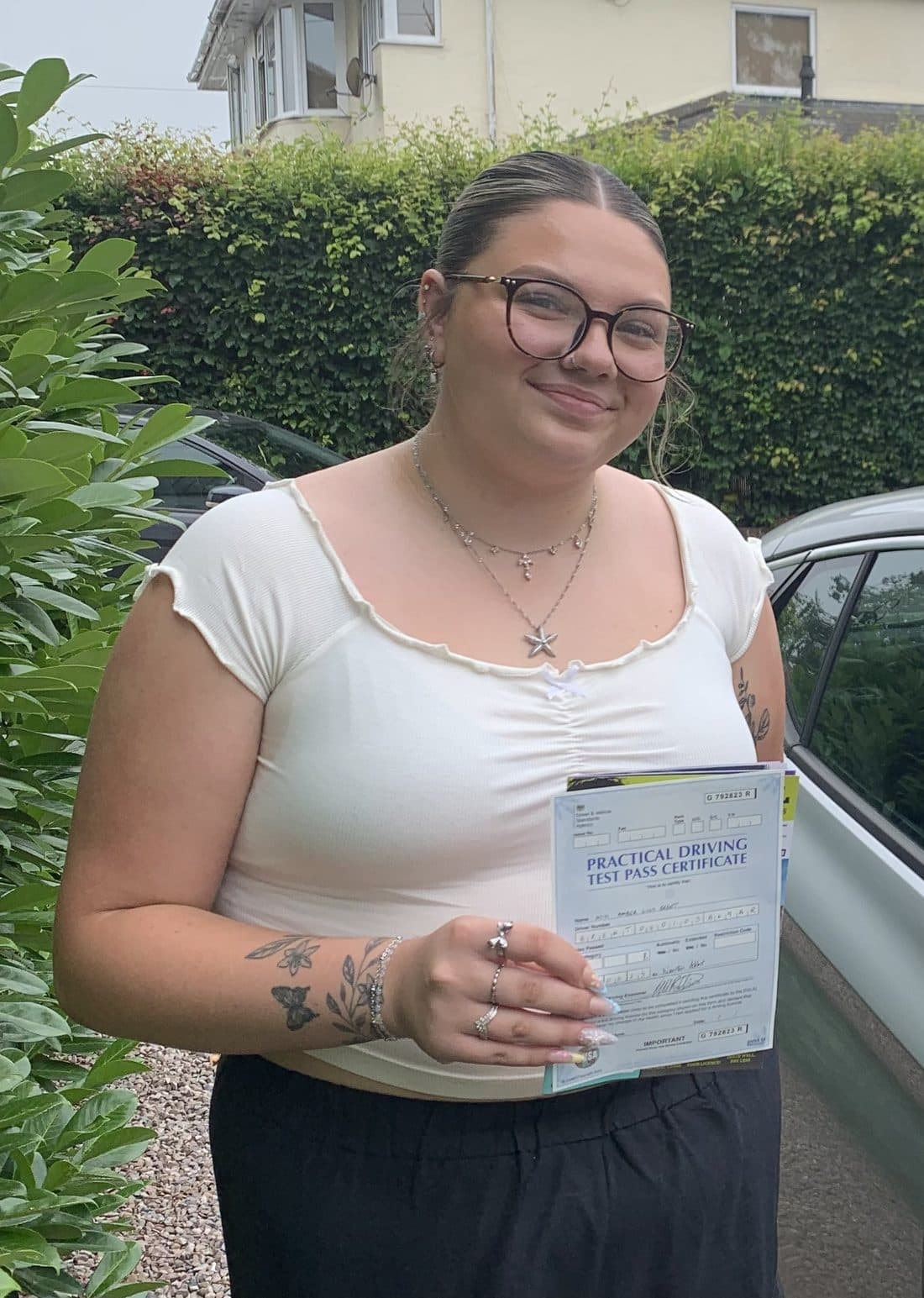 Delighted learner with their practical test pass certificate