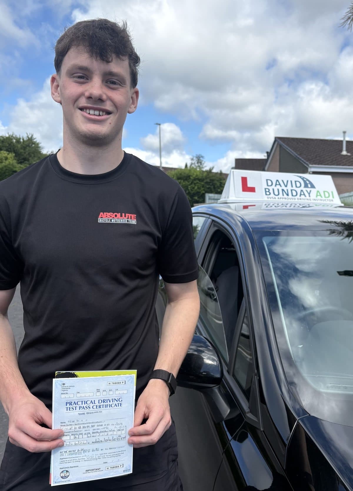 Happy pupil with their practical driving test pass certificate